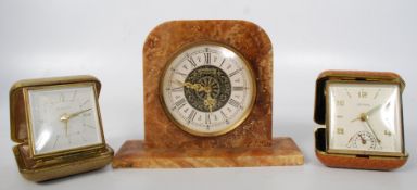 2 early 20th century travel clocks, one being an unusual Estyma with thermometer and another.