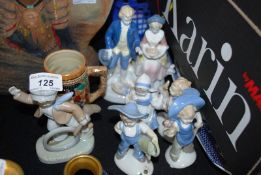 A collection of glazed continental bisque figurines (6 in total) together with a small German beer