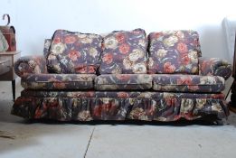 A contemporary Edwardian style sofa with a decorative chintz upholstered frame all having compliant