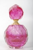 A decorative pink coloured glass perfume bottle with metal rim. 13cm tall.