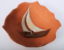 A studio pottery fruit bowl by Kath Green having inset decorative sail boat design, signed to