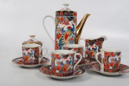 A Japanese coffee set to include coffee pot, sugar bowl,a creamer and 4 cups and saucers. Marked to