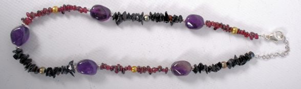 An amethyst and hardstone necklace with silver clasp.