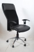 A modern black faux leather office swivel office chair on chrome base having a high back frame.
