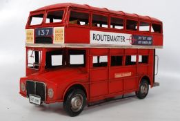 A tin plate toy of a route master bus. 32cm long