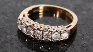 A yellow gold 9ct  half eternity ring having inset 7 stones on multipoint bezels. Tested to 50pts.