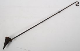 An ecclesiastical iron candle snuffer