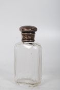 A silver topped scent bottle hallmarked for 1885. 10cms tall