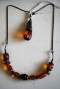 A decorative 19th century amber and white metal necklace having amber stones with white metal