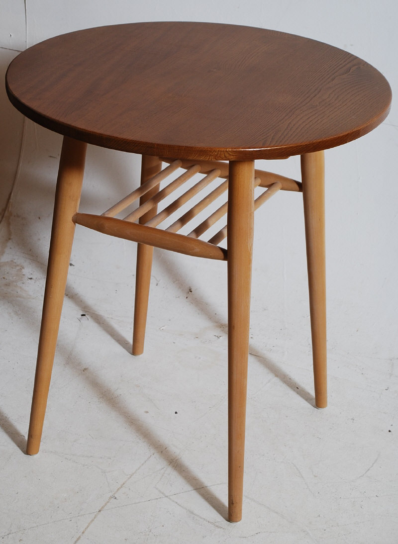 An Ercol beech and Elm 'Golden Dawn' rare circular occasional table. Shaped supports to the base