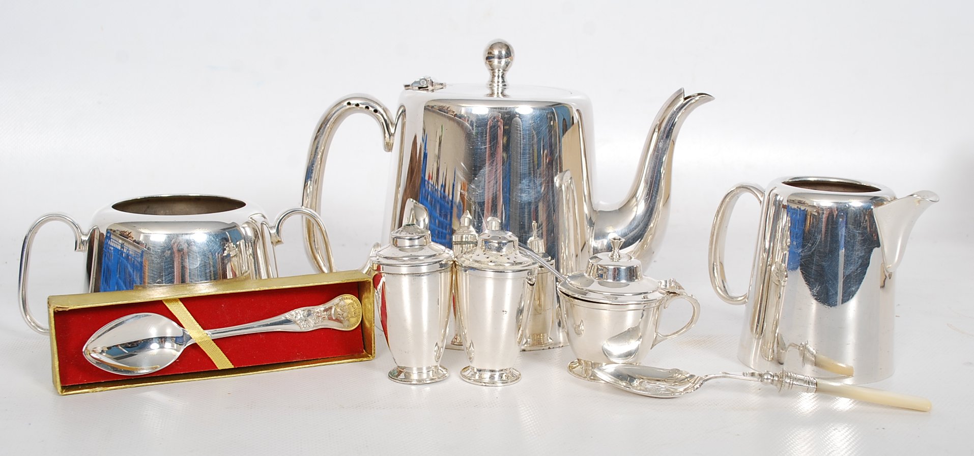 A good quality silver plate teapot together with the matching creamer and sugar bowl along with a