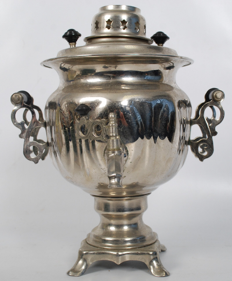 A silver plate electric samovar of decorative form. Bulbous body with waisted neck on circular