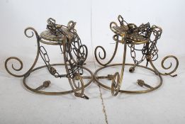 A pair of early 20th century brass tubular chandeliers having multiple bulb heads to each hanging on