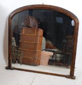 A large Victorian style mahogany overmantle mirror. The mahogany frame having shaped sides with feet