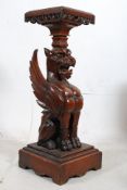 A Victorian mahogany and marble griffin pedestal / plant stand. The square plinth base having a