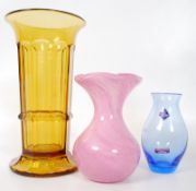 An Allum Isle of Wight pink blown glass vase along with two other pieces of coloured glass.