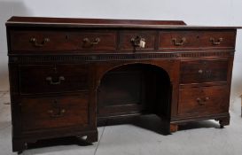 A large 19th century solid mahogany twin pedestal dog kennel desk in the adams revival style.