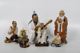 A collection of 6 Chinese figurines, all varying, to include scholars, seated gentleman etc