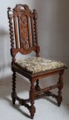 A Victorian carloean style carved oak hall chair. The barley twist legs united by stretchers