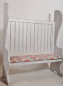 A shabby chic painted pine oak hall settle. Decorative shaped sides with upholstered panelled seat