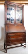 1930's Art Deco oak bureau bookcase.Cup and cover legs united by stretchers supporting a chest of