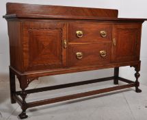 An Edwardian solid mahogany sideboard. Stood on hoof feet united by stretchers supporting a wide