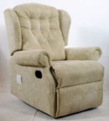 A contemporary Chenille upholstered adjustable reclining upright armchair, with handle to side.