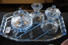 An aquamarine coloured glass dressing table set