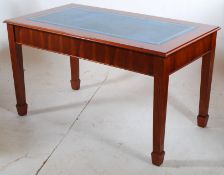 A Georgian style yew wood office writing table having inset blue leather writing surface.