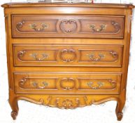 A french 20th century fruitwood commode chest of drawers in the louis 15th style. Shaped legs with a