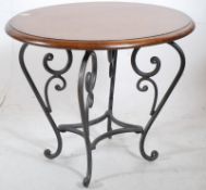 A decorative fruitwood and cast metal occasional table. The rococo shaped base having a good