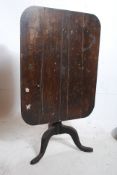 A 19th century country oak tilt top pedestal dining / occasional table. The turned column with