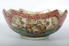An early 20th century Japanese Satsuma bowl decorated with scholars and garden scenery. 24.5cms