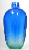 A tall irridescent blue and green studio glass vase having angular bowl with waisted neck. 34cms