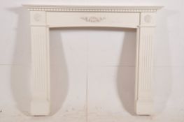 An Adams style painted fireplace surround. The reeded columns to sides having shelf atop and
