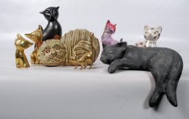 A collection of ceramic and brass cat figurines to include a Tremar cat money box