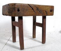 A 19th century French elm wood butchers block. Squared legs supports united by stretchers supporting