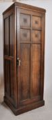 A 1920's Jacobean Revival oak sentry box hall cupboard / wardrobe. Plinth base with full length
