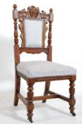 A Victorian carved oak green man hall chair / dining chair. The turned legs united by stretchers.