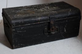 A military style tin trunk being ebonised having painted notation to the hinged lid. 29cms High x