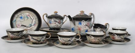 A Japanese translucent tea service with flowing dragon decoration