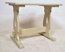 A 1920's oak shabby chic painted refectory dining table. The lyre supports having shaped legs united