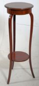 An Edwardian mahogany inlaid plant stand  / Jardiniere having shaped supports with twin circular