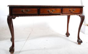 An antique Georgian style mahogany partners writing table.