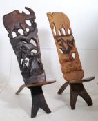 A pair of large African tribal "Chiefs" chairs, each with pierced backs and shaped scrolling