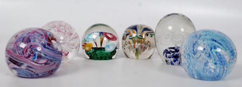 A quantity of glass paperweights to include control bubble and others (7 in total)