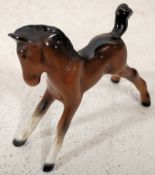 A Beswick figurine of a young fowl horse bearing Beswick stamps to the underside. 8cm tall.