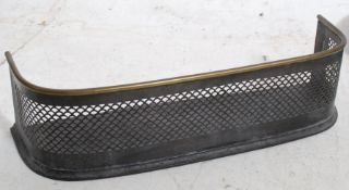 A Victorian brass and fret worked fire fender of small proportions having banded brass top,