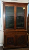 A large Victorian mahogany library bookcase cabinet. Plinth base with carved cupboard doors