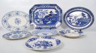 An assortment of blue and white plates to include dinner plates, meat platter, Willow, Spode,